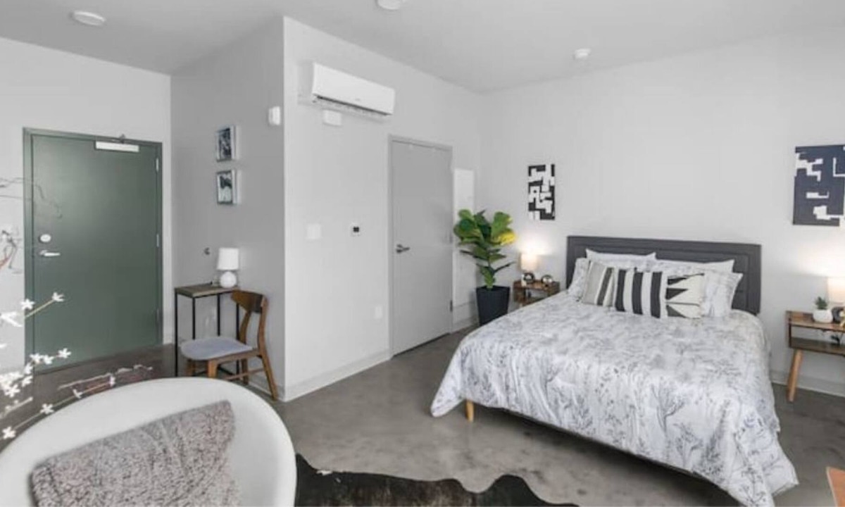 Central City Apartment | Modern loft with rooftop deck, fitness center, and private parking.