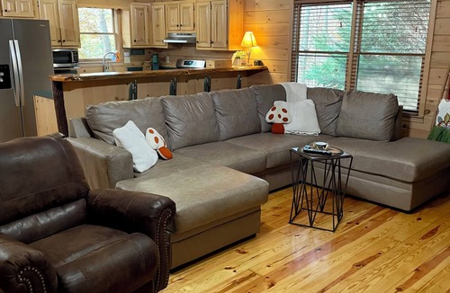 Madisonville Cabin | Creekfront Cabin with Waterfall. Hot Tub, Fire Pit, Gameroom, and more.