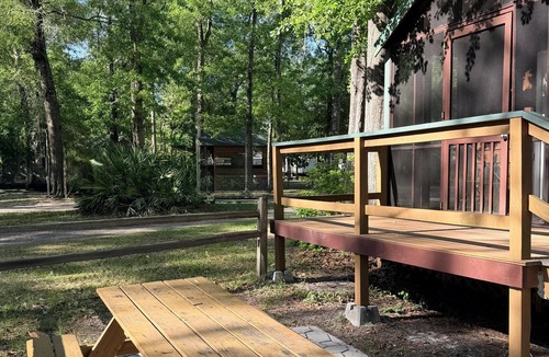 Folkston Cabin | Deluxe Cabin - The Gator Hole - Our Deluxe Cabins offer comfort with a true Okefenokee feel. Climate controlled, private, and set in a quiet part of the campground.