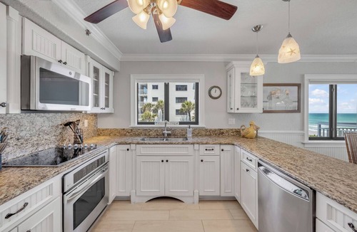 New Smyrna Beach Condo | Direct oceanfront corner 3/2 with a large wrap around balcony and heated pool