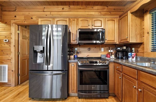 Leitchfield House | Expansive lakefront cabin with game room and yard!