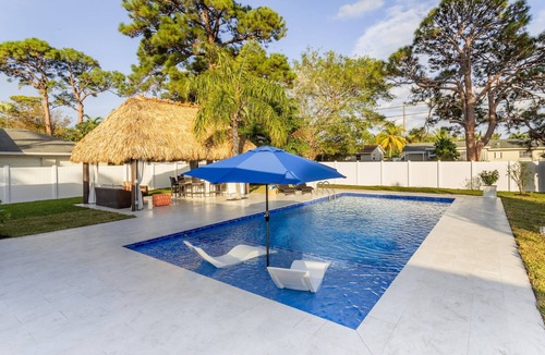 Boynton Beach House | Golfers Green Retreat with 35' Heated Saltwater Pool & Tiki. Pet Friendly!