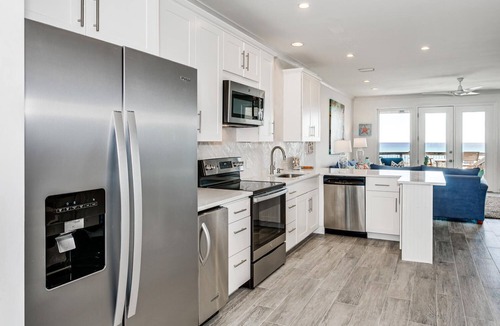 Navarre Beach House | Luxury Beachfront: TWO Kings Beds Beach Chairs & Paddleboard included. Sleeps 14