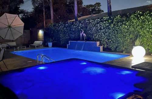 Poinsettia Heights Villa | Palms Retreat! Giant Heated Pool-HotTub-FirePit-5Min2Beach-Pets-EV Chgr
