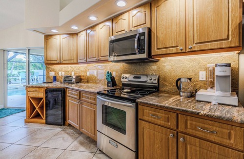 Caloosahatchee Villa | Sleeps up to 10 - game room - pool with hot tub - Stars Vacation Rentals