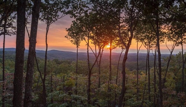 Amber Sunsets dazzles with panoramic views, hot tub luxury, a custom firepit, screened porch, pool table, and pet-friendly hospitality!