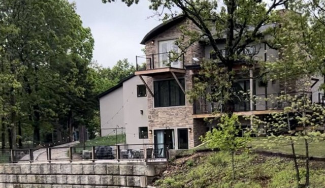 Beautiful Modern mountain getaway overlooking water with fountain.