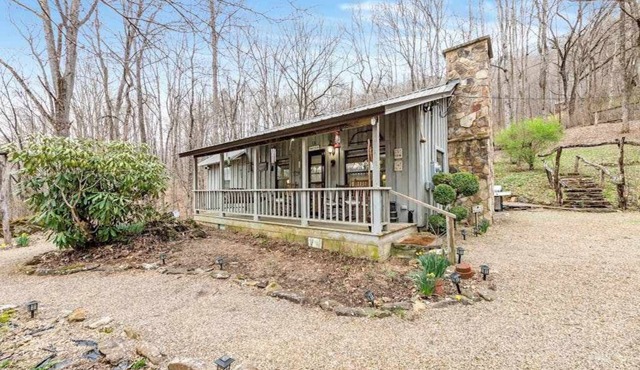 Charming acreage with a grill, W/D, large porch, and wood-burning fireplace