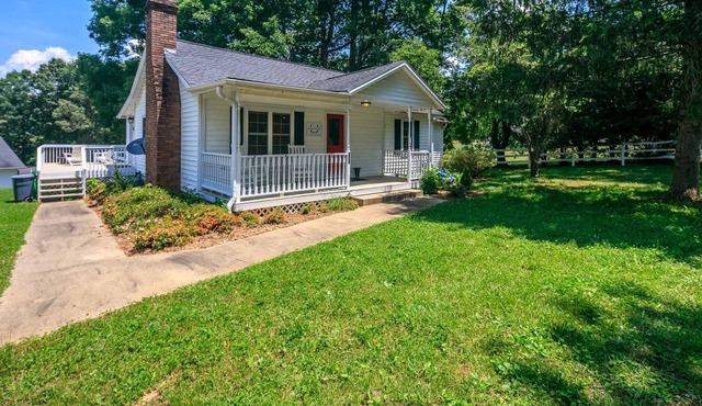 Classic white farmhouse style cottage. Perfect for a serene country getaway.