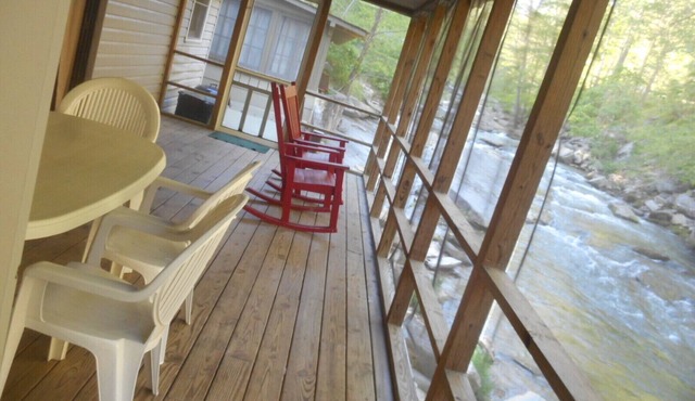 On the River's Edge! Rocking chairs on large screened porch on river's edge.